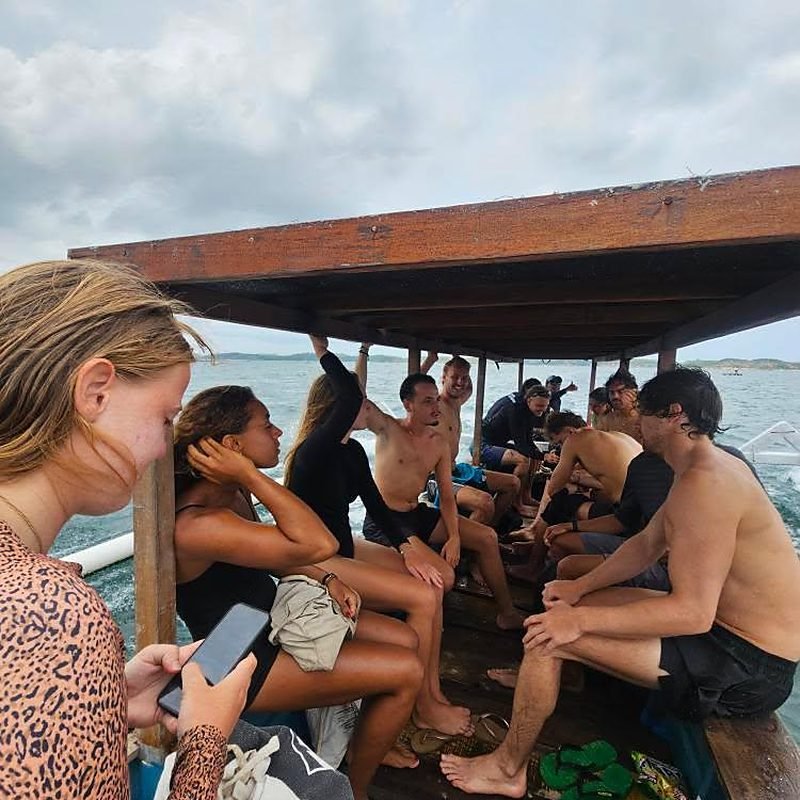 Waiting out the midday tide under the warung roof