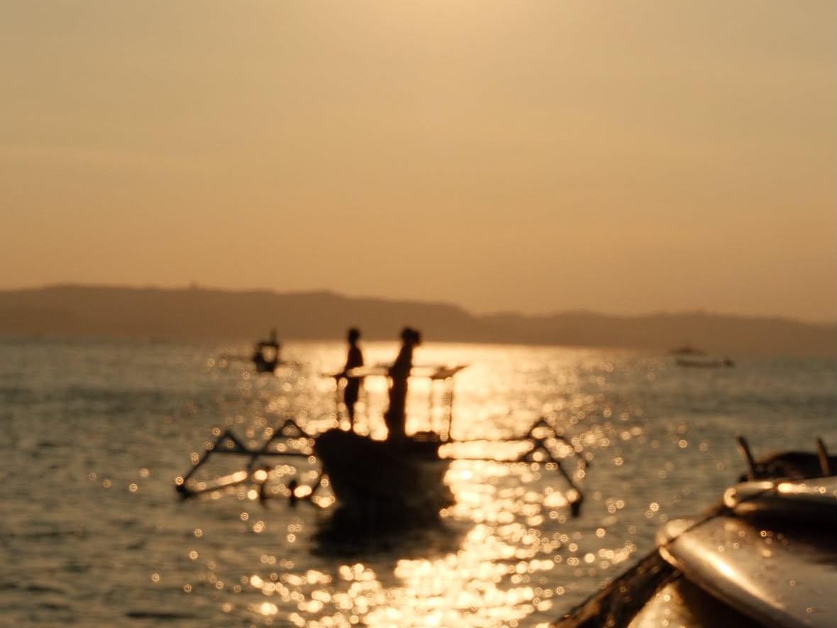 Sunset over Awang Bay as the boat heads back to the harbour